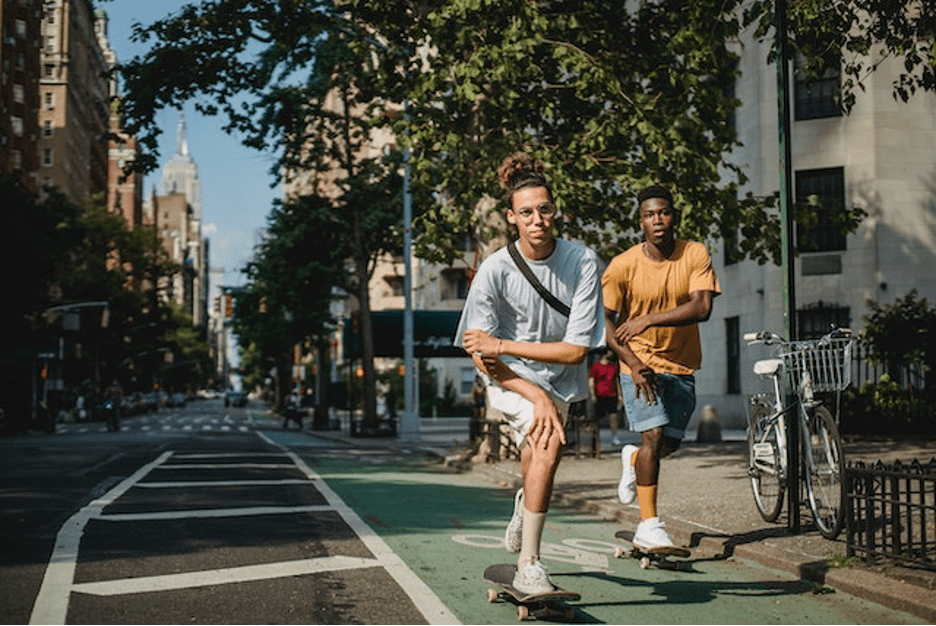 Two people skating during a sunny day